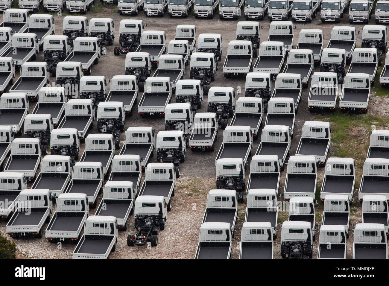 An aerial view of industrial light vehicles parked neatly in an open space. Stock Photo