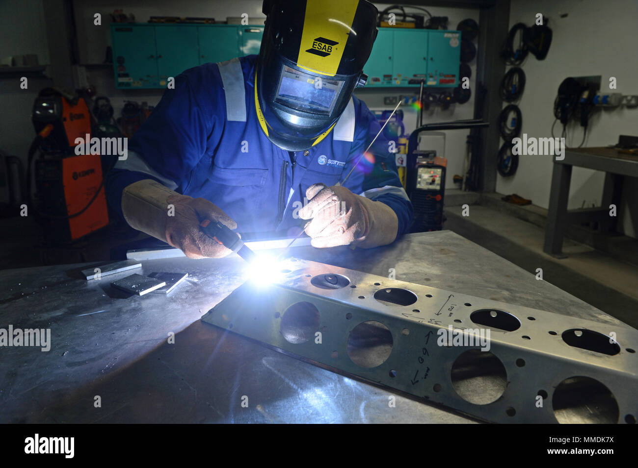 Welder welding together some stainless steel with a mig welder Stock Photo