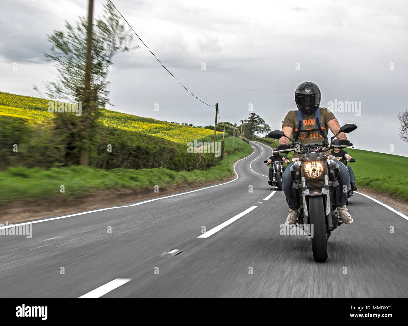 Bikers riding on the road. Motorcycle club out for a ride in England Stock Photo