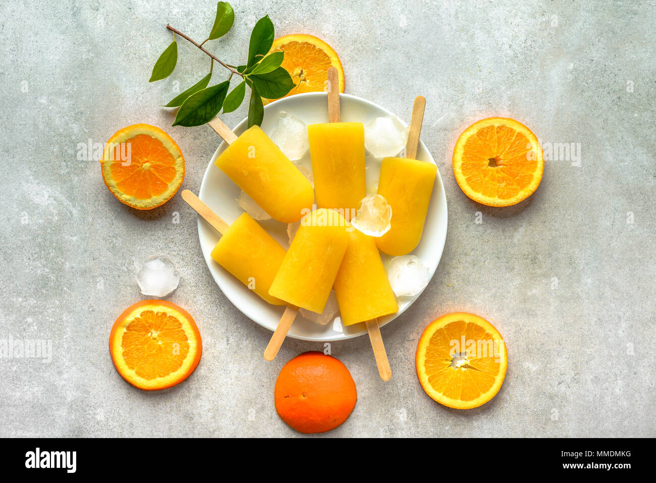 Homemade popsicles with orange juice, ice lollies on sticks, top view
