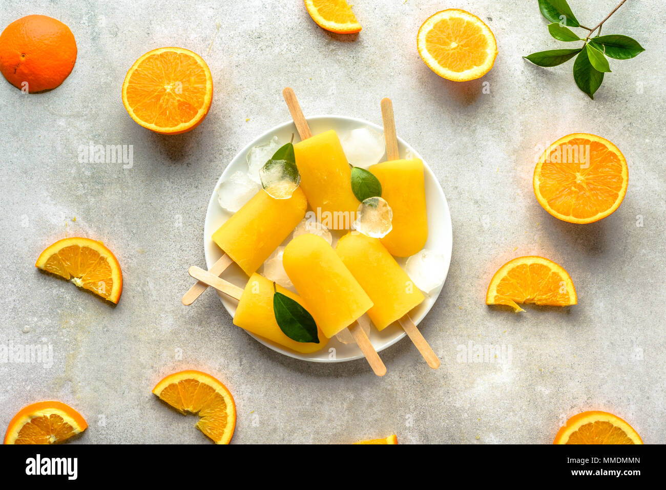 Homemade popsicles with orange juice, ice lollies on sticks, top view