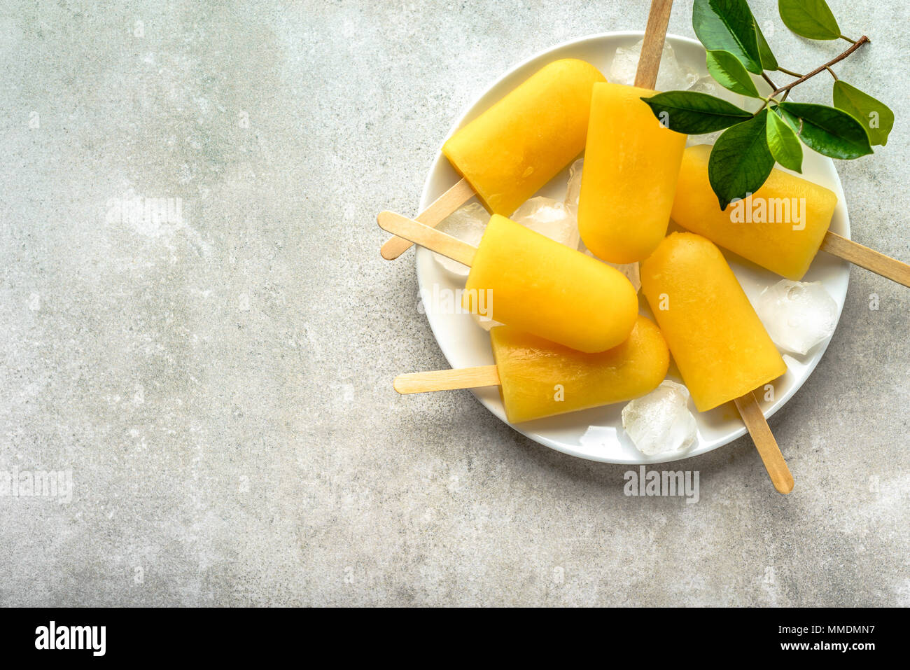 Homemade popsicles with orange juice, ice lollies on sticks, top view