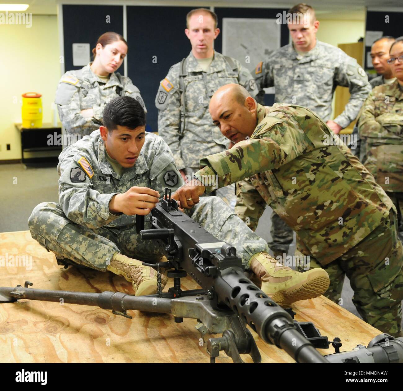 U.S. Army Reserve Sgt. Freddie Roman-Casiano, movement transportation coordinator, 382nd Combat Service Support Battalion out of Tacoma, Wash., receives primary marksmanship instruction on an M2A1 machine gun from Staff Sgt. Jesus Valles, 208th Transportation Company out of Marana, Ariz., and a primary marksmanship instructor for Task Force Coyote, during Operation Cold Steel II at Fort Hunter Liggett, Calif., Oct. 18, 2017.  Operation Cold Steel is the U.S. Army Reserve’s crew-served weapons qualification and validation exercise to ensure that America’s Army Reserve units and Soldiers are tra Stock Photo