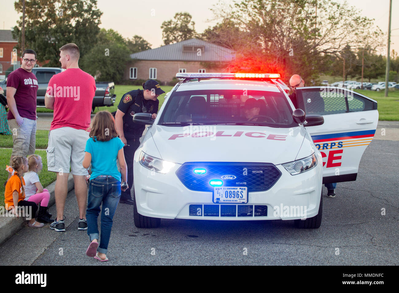 Police officers with New Orleans Police Department let families sit in a patrol car to see how