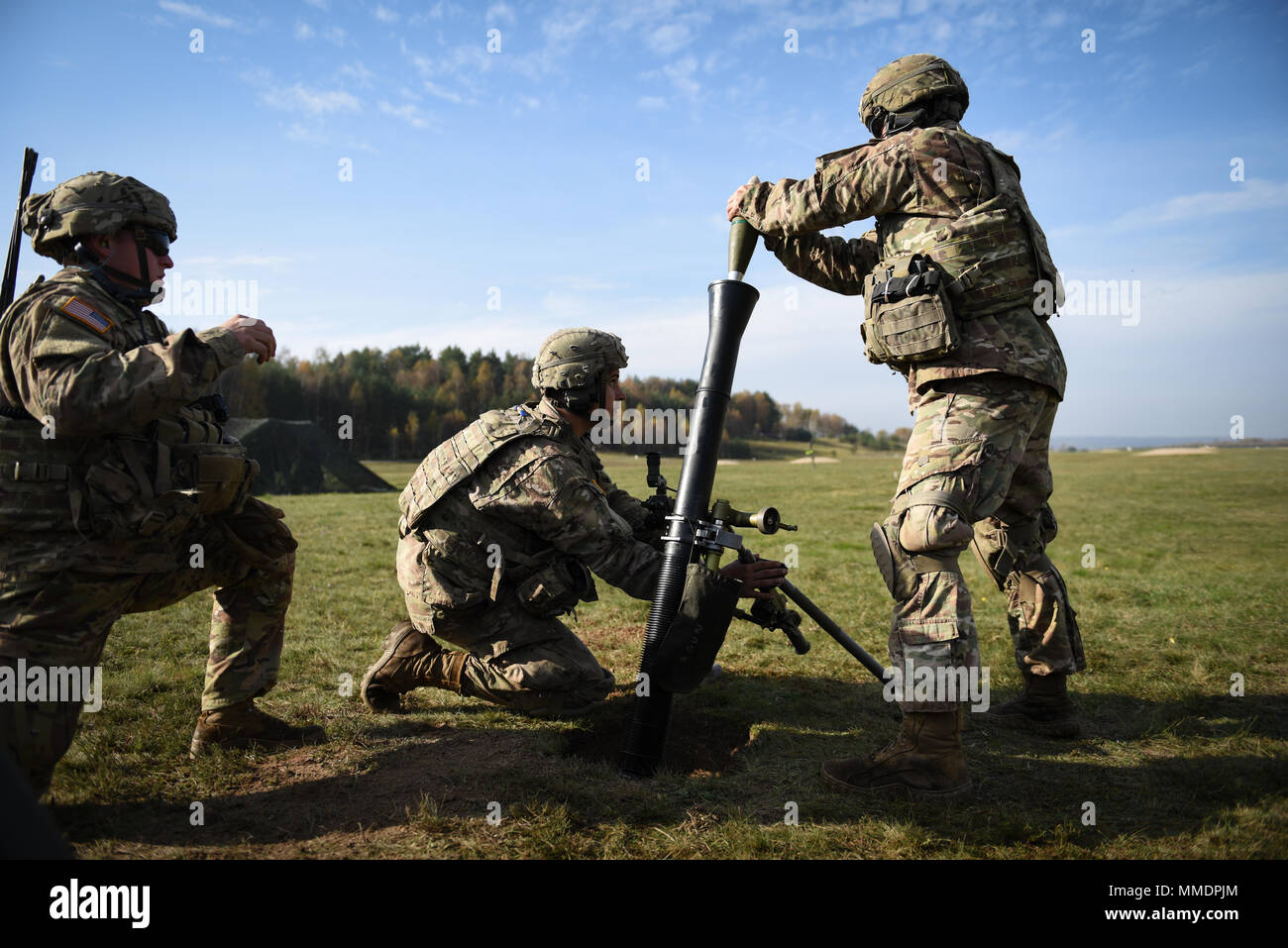 GRAFENWOEHR, Germany -- U.S. Army Paratrooper Pfc. James West, a mortar team member assigned to Headquarters and Headquarters Company, 2nd Battalion, 503rd Infantry Regiment (Airborne), 173rd Airborne Brigade, prepares to fire the M252A1 81mm Mortar System during a live fire range on October 20th, 2017. The 173rd Airborne Brigade is the U.S. Army’s Contingency Response Force in Europe, providing rapidly deploying forces to the U.S. Army Europe, Africa and Central Command Areas' of Responsibility within 18 hours. Stock Photo