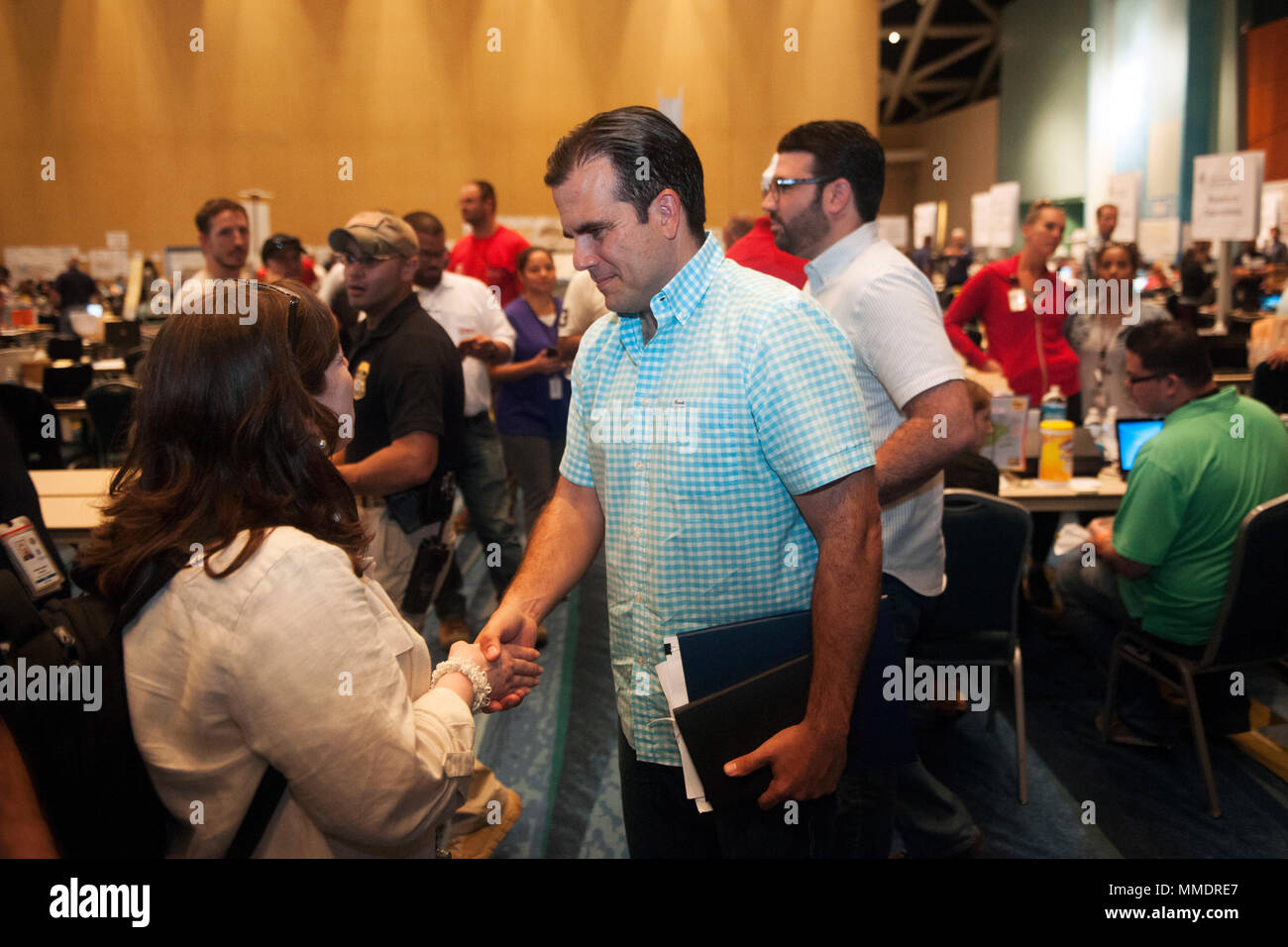 Governor Ricardo Rossello greets workers inside the Joint Field Office