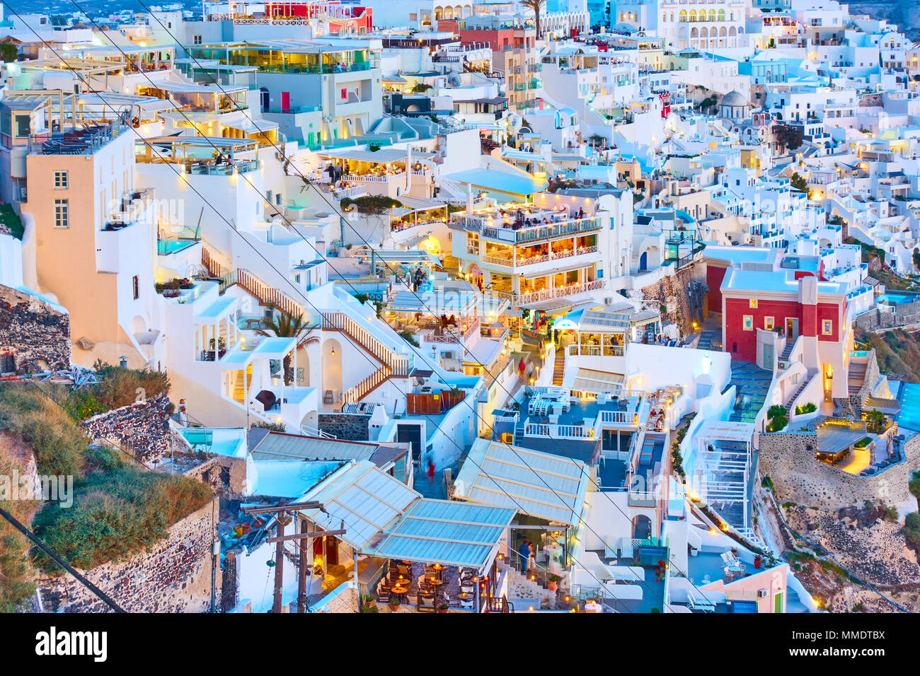 Terraces with bars, cafes and restaurants of Thira town in the evening, Santorini, Greece Stock Photo