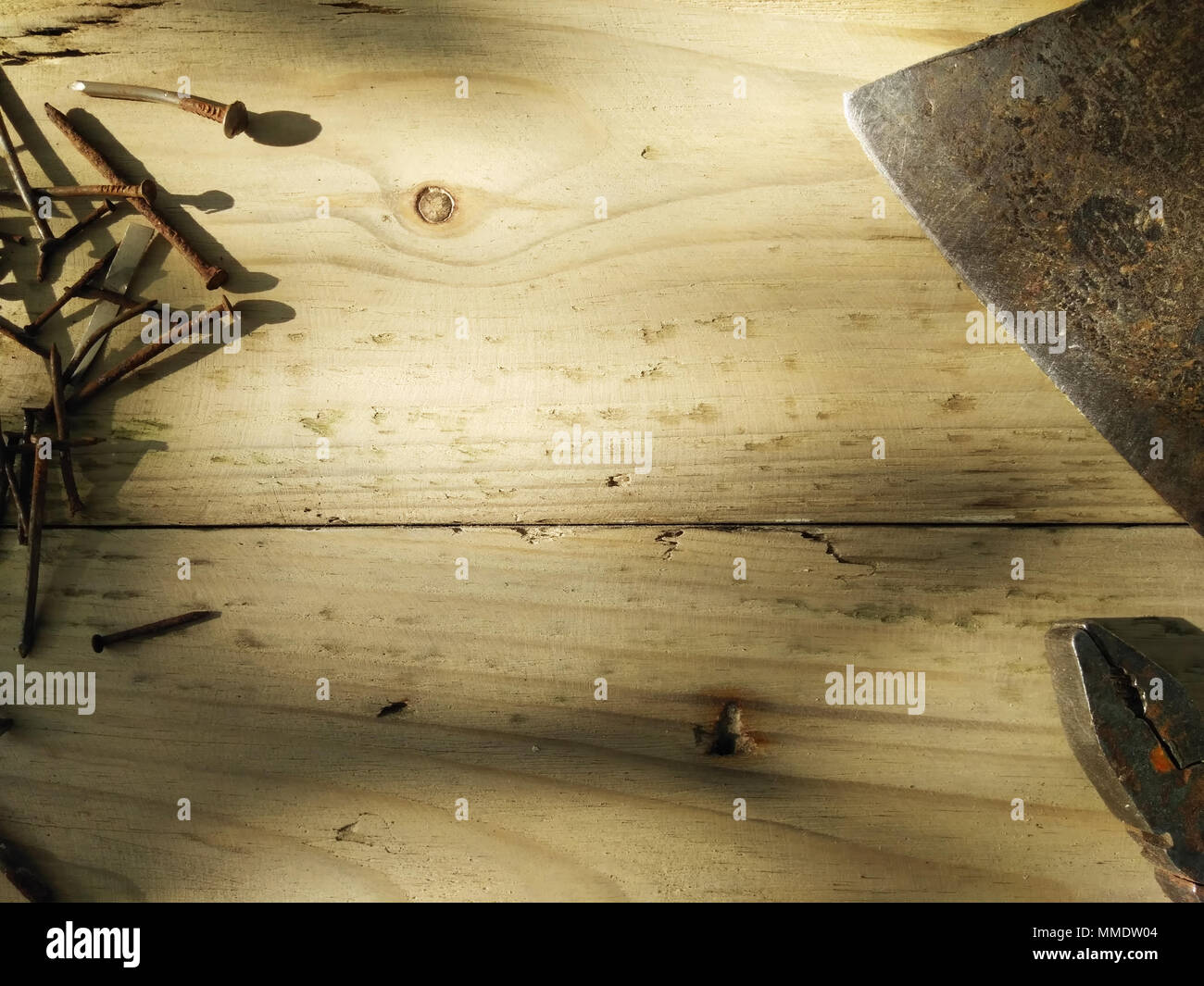 Joiner's tools set. Real work background. Pliers, old rusty nails and axe Stock Photo