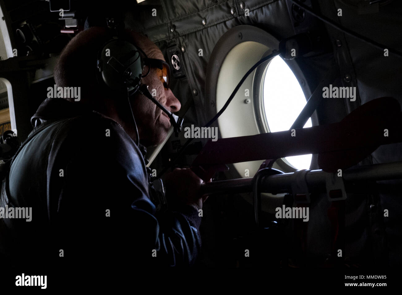 Gen. Mike Holmes, commander of Air Combat Command, looks out a window of an HC-130J Combat King II, Oct. 17, 2017, on his flight to Moody Air Force Base, Ga. During the flight, Airmen from the 347th Rescue Group demonstrated helicopter air-to-air refueling and a static line jump from pararescuemen assigned to the 38th Rescue Squadron. (U.S. Air Force photo by Tech. Sgt. Zachary Wolf) Stock Photo