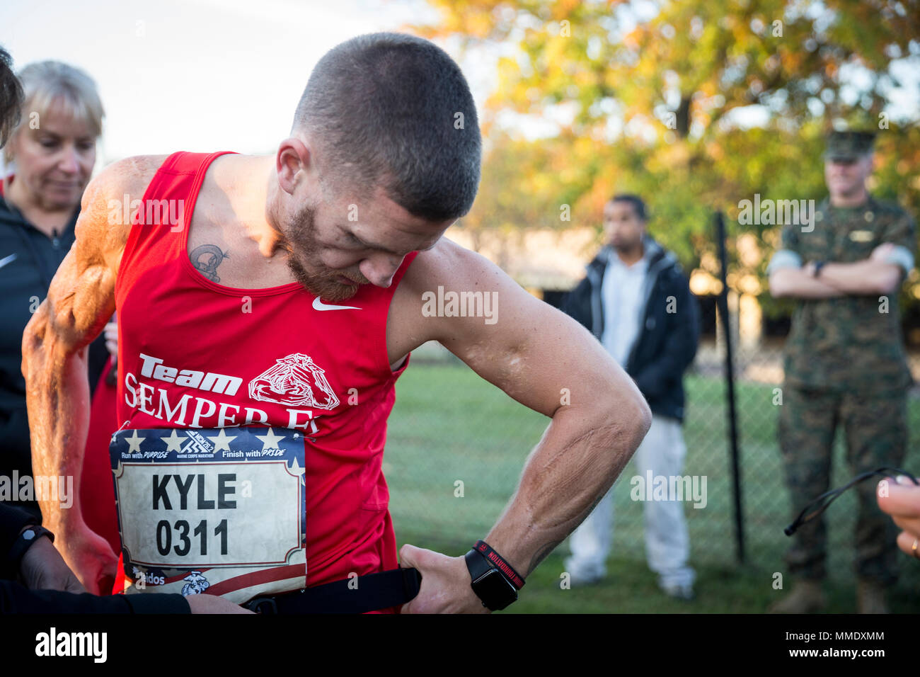 Retired U.S. Marine Corps Cpl. Kyle Carpenter, Medal of Honor recipient, adjusts his uniform prior to the 42nd annual running of the Marine Corps Marathon, traveling on a monumental course through Washington, D.C. and finishing at the Marine Corps War Memorial, Arlington, Va., Oct. 22, 2017. Also known as 'The People's Marathon,' the 26.2 mile race drew roughly 30,000 participants to promote physical fitness, generate goodwill in the community, and showcase the organizational skills of the Marine Corps. (U.S. Marine Corps photo by Sgt. Timothy Turner) Stock Photo