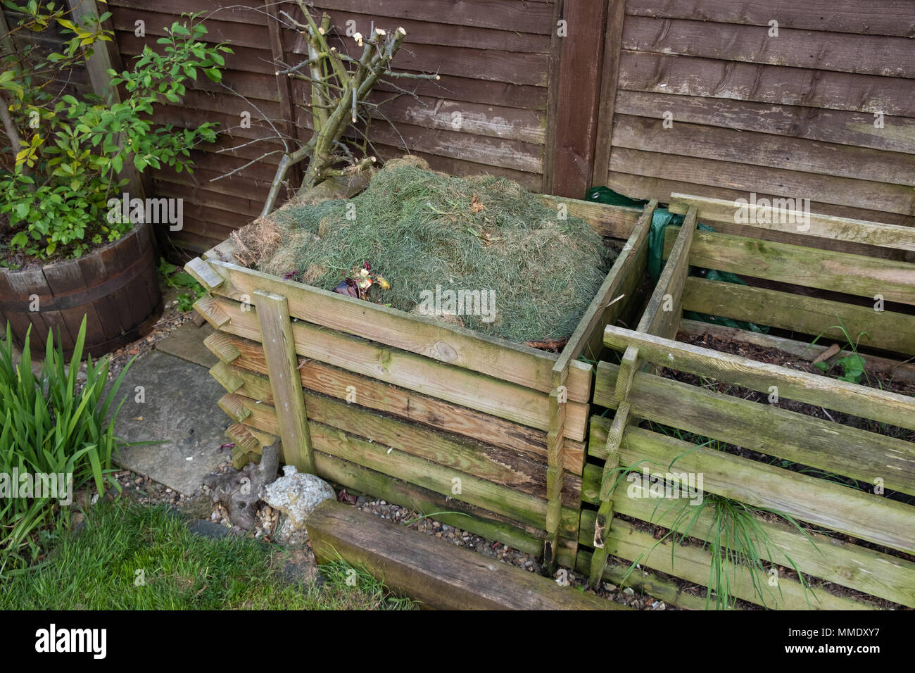 Two garden compost heaps, one full of grass cuttings Stock Photo Alamy