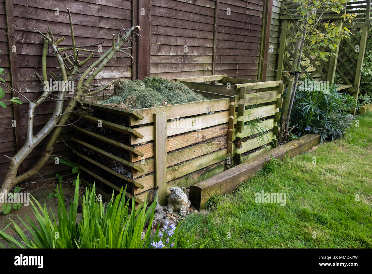 Two garden compost heaps, one full of grass cuttings. Stock Photo
