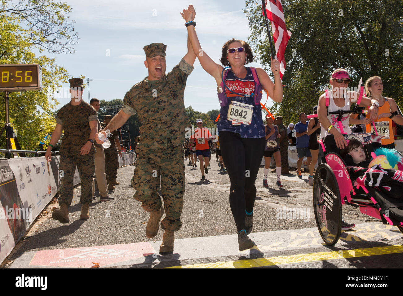 U.S. Marine Corps Col. Joseph M. Murray, base commander for Marine Corps Base Quantico, and Amanda Eason, a native of Quantico, Virginia, cross the finish line of the 42nd annual running of the Marine Corps Marathon, traveling on a monumental course through Washington, D.C. and finishing at the Marine Corps War Memorial, Arlington, Va., Oct. 22, 2017. Also known as 'The People's Marathon,' the 26.2 mile race drew roughly 30,000 participants to promote physical fitness, generate goodwill in the community, and showcase the organizational skills of the Marine Corps. (U.S. Marine Corps photo by La Stock Photo