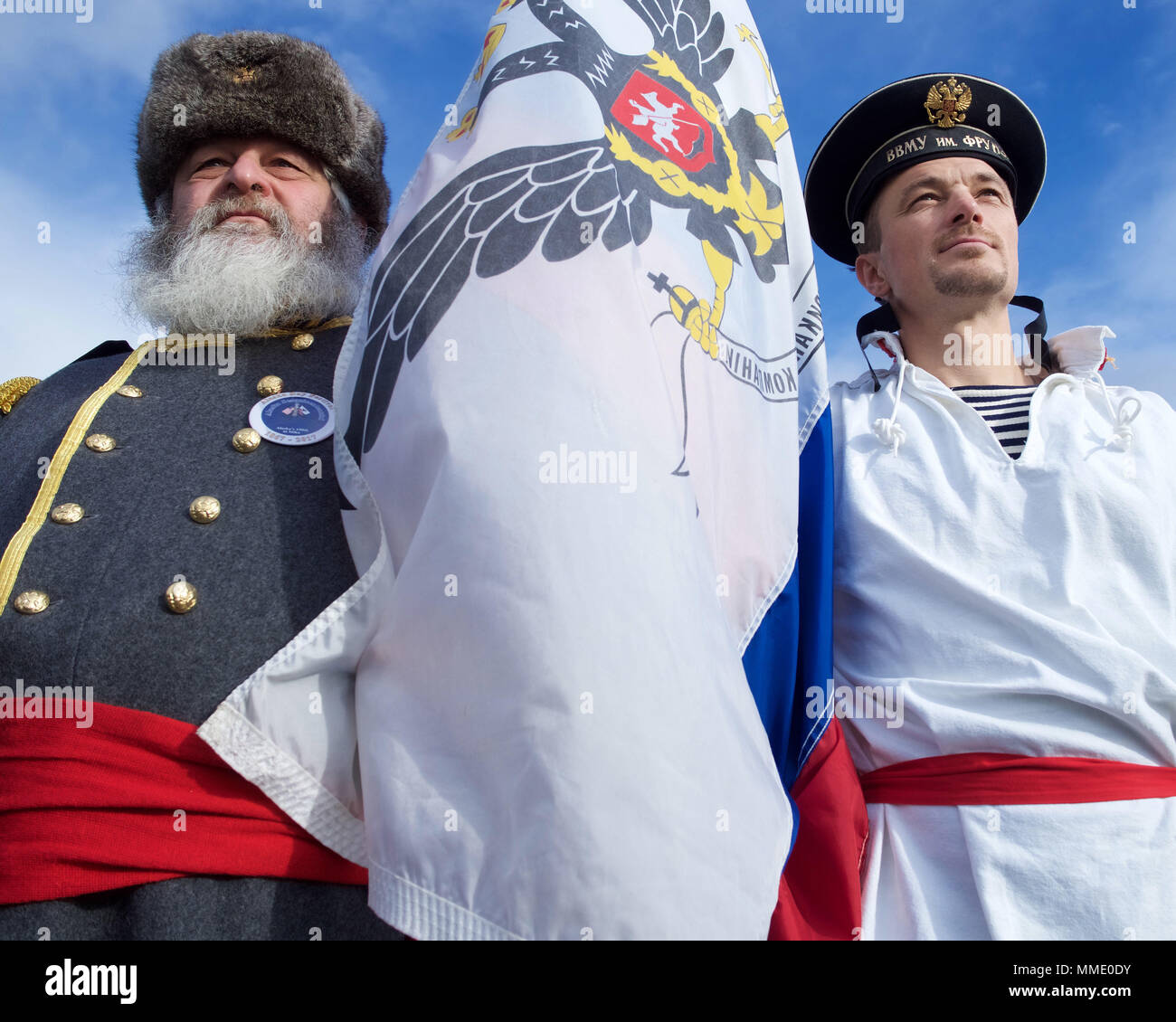 Ron Conklin portrays Russian Commissioner Alexi Pestchouroff, and Roman Sorokin portrays a Russian sailor at Castle Hill, Sitka, Alaska, during the Oct. 18, 2017, reenactment of the transfer of Alaska from Russia to the United States. Conklin has portrayed Pestchouroff in the reenactment for nearly two decades. (U.S. Army National Guard photo by Sgt. David Bedard/released) Stock Photo