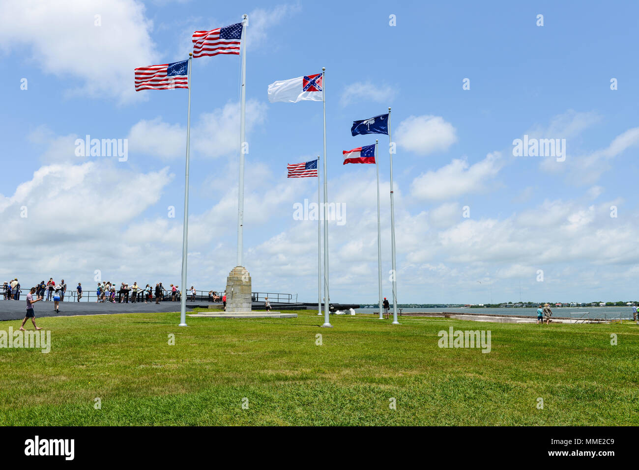 American Flags - Six flags, a 50-star United States flag and five historic flags, flying on blue sky over Fort Sumter, Charleston, South Carolina, USA Stock Photo