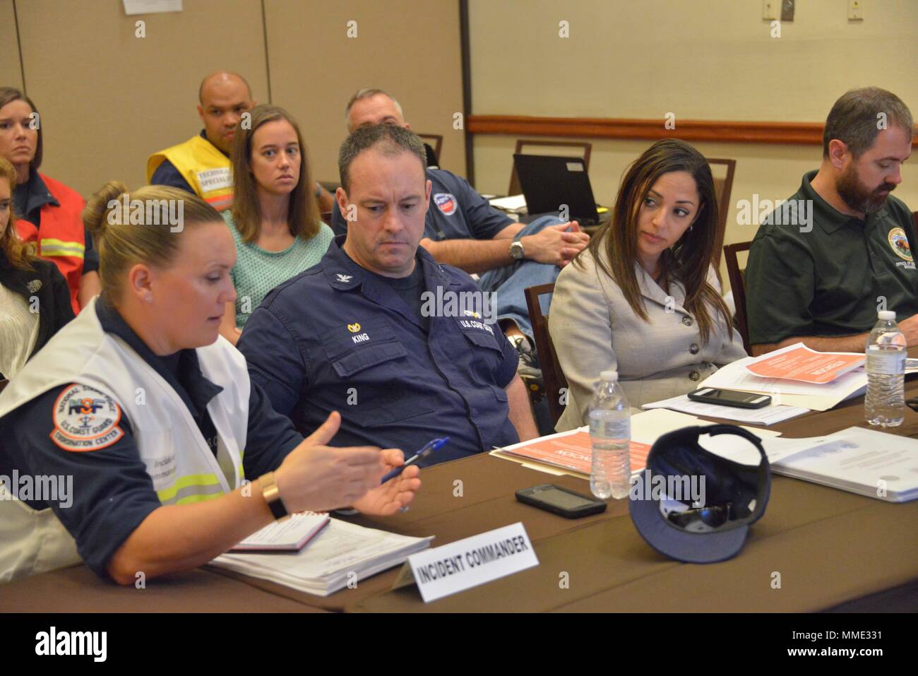 Puerto Rico Department of Natural and Environmental Resources Secretary  Tania Vasquez Rivera (right) meets with U.S. Coast Guard Capt. Eric King,  the Sector San Juan commanding officer and federal on-scene coordinator, and