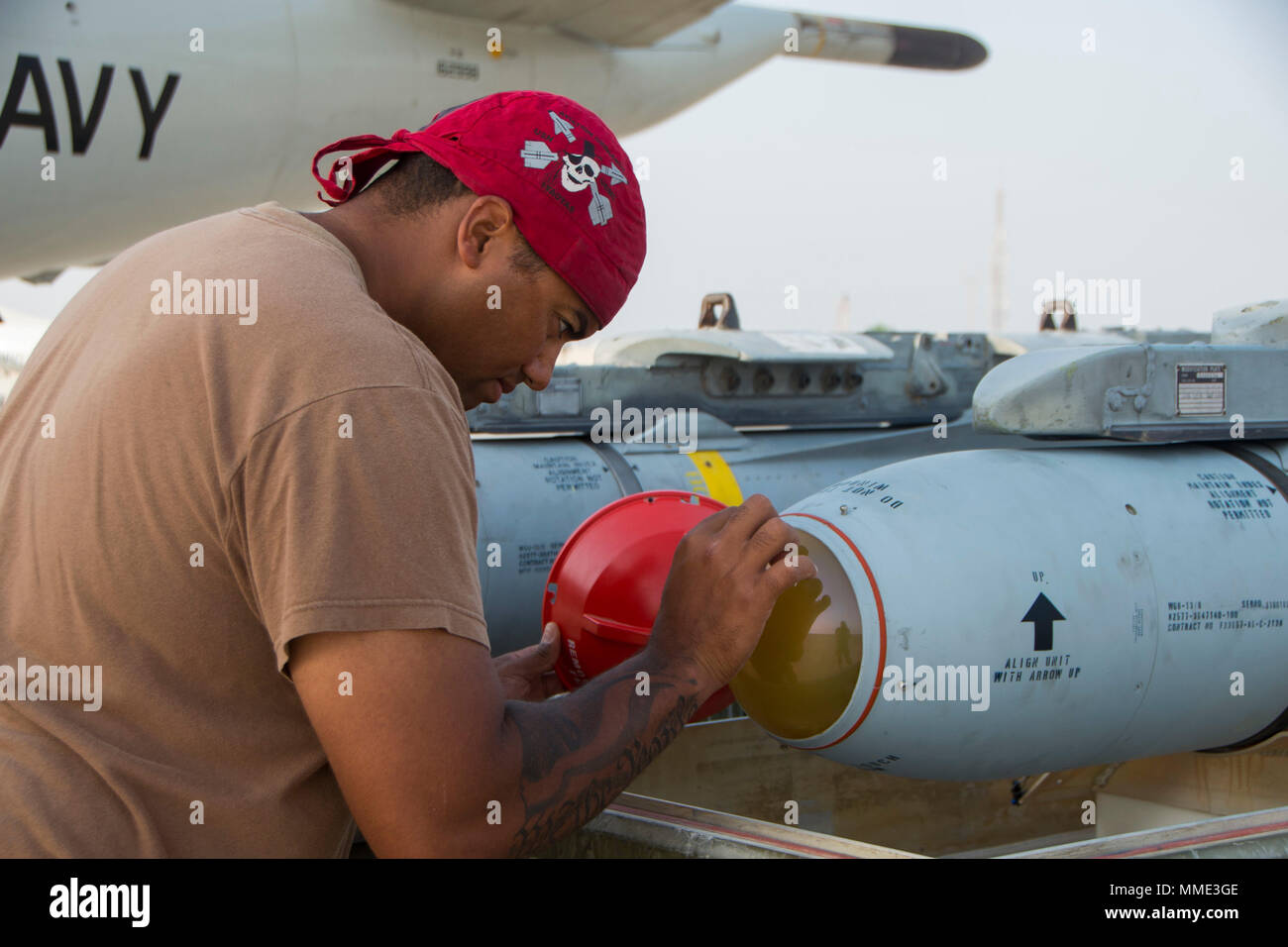 171022-N-CL765 U.S. 5TH FLEET AREA OF OPERATIONS (Oct. 22, 2017) Aviation Ordnanceman 1st Class John Mitchell, assigned to Patrol Squadron (VP) 40, inspects the radome of a AGM-65F missile during a loading evolution with the P-3 Orion aircraft. VP-40 is currently deployed to the 5th, 6th and 7th fleet areas of operations. (U.S. Navy Photo by Mass Communication Specialist 3rd Class Jakoeb Vandahlen/Released) Stock Photo
