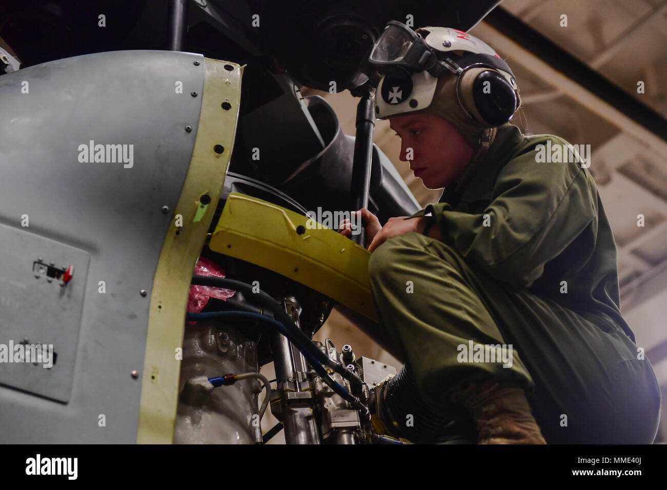 171024-N-BK384-229 MEDITERRANEAN SEA (Oct. 24, 2017) U.S. Marine Sgt. Erin Maloney, from Wilmington, Delaware, inspects an AH-1Z Viper attack helicopter, attached to Marine Medium Tiltrotor Squadron (VMM) 161 (reinforced), in the hangar bay of the San Antonio-class amphibious transport dock ship USS San Diego (LPD 22) Oct. 24, 2017. San Diego is deployed with the America Amphibious Ready Group and the 15th Marine Expeditionary Unit to support maritime security and theater security cooperation in efforts in the U.S. 6th Fleet area of operations. (U.S. Navy photo by Mass Communication Specialist Stock Photo