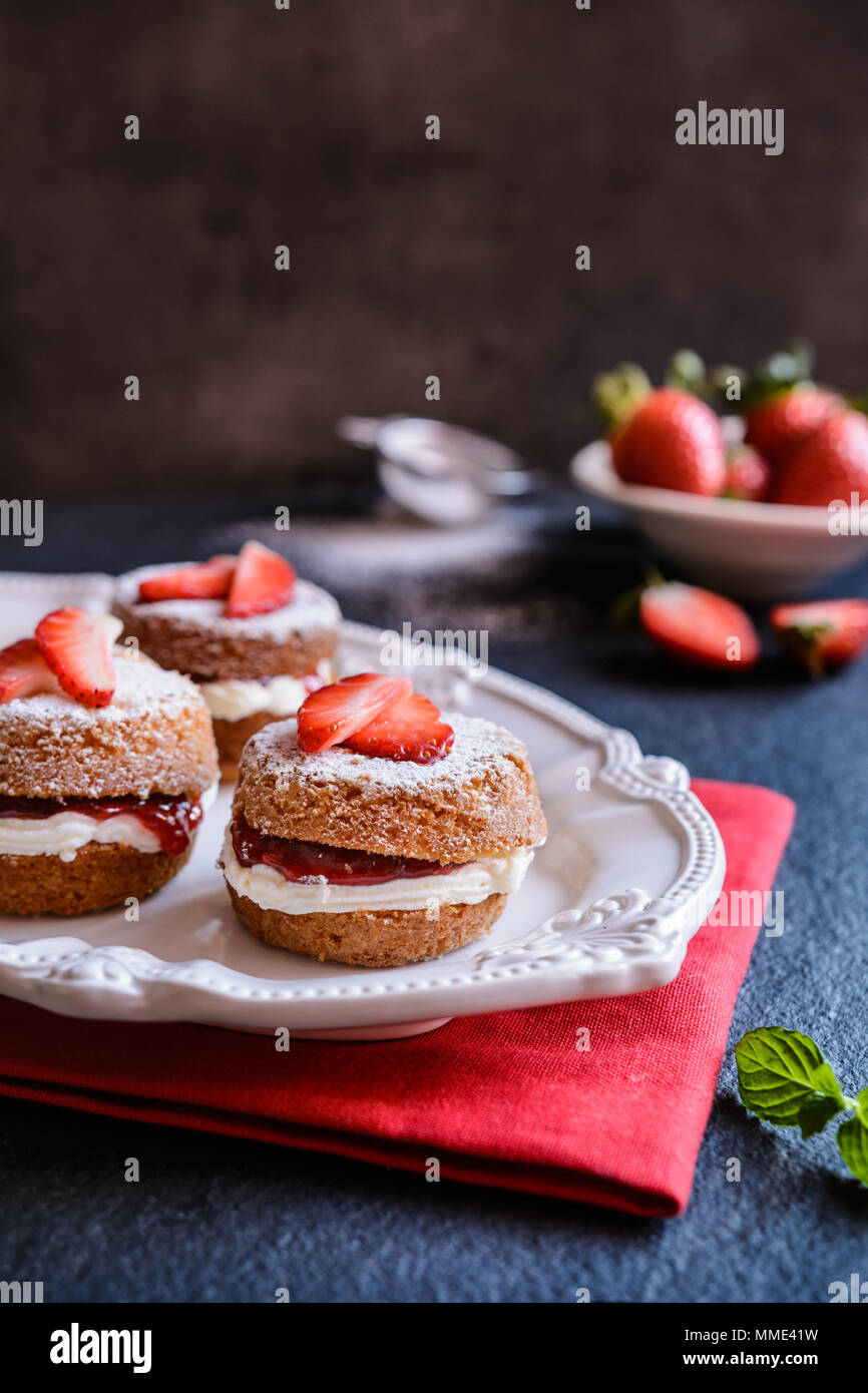 Traditional mini Victoria sponge cakes with whipped cream and