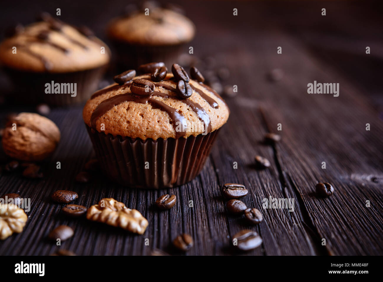 Coffee muffins with grated walnut and topped with chocolate Stock Photo