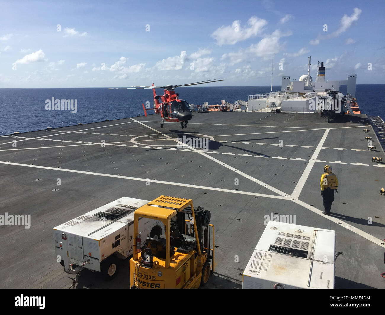 An HH-65 Dolphin helicopter crew from Coast Guard Air Station Borinquen, Puerto Rico, conducted helicopter operations with the USNS Comfort Oct. 25, 2017.  This training gave the pilots and aircrew the necessary familiarization to conduct medical evacuations to the hospital ship in response to Hurricane Maria. U.S. Coast Guard photo by Lt. Waymondo Brown. Stock Photo