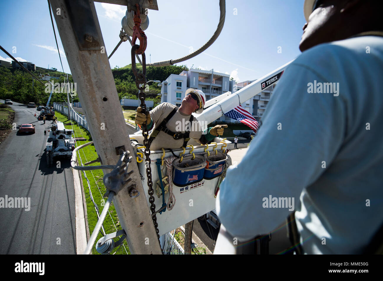U.S. Army Sergeant Eric Elder, a power line distribution specialist assigned to Delta Company, 249th Engineer Battalion (Prime Power), Cranston, RI, inspects a damaged power line in Río Grande, Puerto Rico, Oct. 25, 2017. Hurricane Maria formed in the Atlantic Ocean and affected islands in the Caribbean Sea, including Puerto Rico and the U.S. Virgin Islands. U.S. military assets supported FEMA as well as state and local authorities in rescue and relief efforts.   (U.S. Air Force photo by Tech. Sgt. Larry E. Reid Jr.) Stock Photo