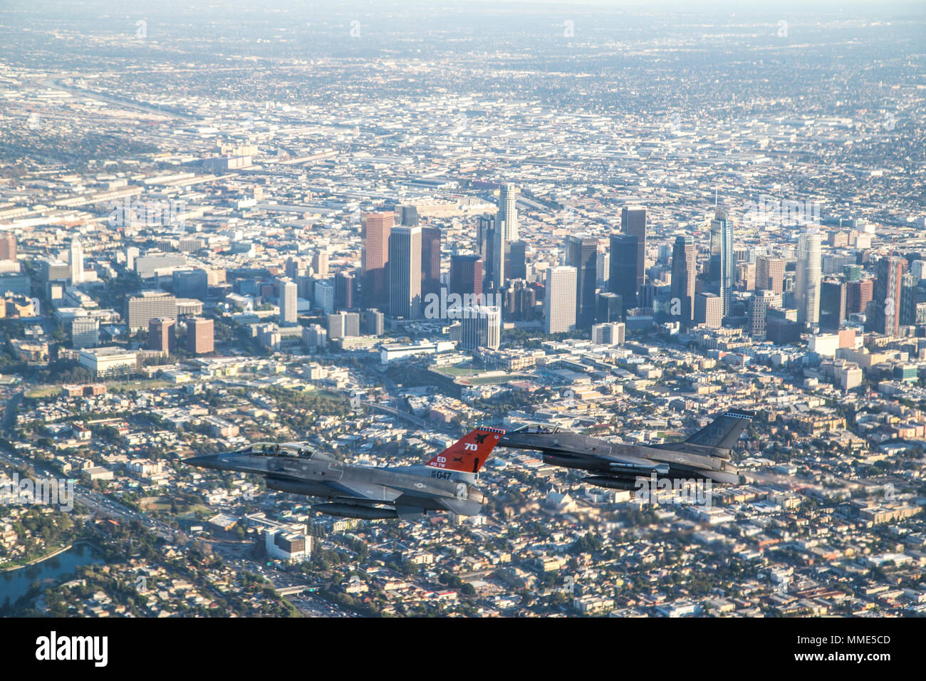 LOS ANGELES (Oct. 25, 2017) F-16 Fighting Falcons from the 416th Flight Test Squadron circle Downtown Los Angeles as part of a four-ship flyover that kicked off Game 2 of the World Series at Dodger Stadium. The 416th Flight Test Squadron conducts developmental testing for the F-16 while supporting additional objectives throughout the Air Force, which recently observed it's 70th anniversary of supersonic flight. (U.S. Air Force photo by Christopher Okula) Stock Photo