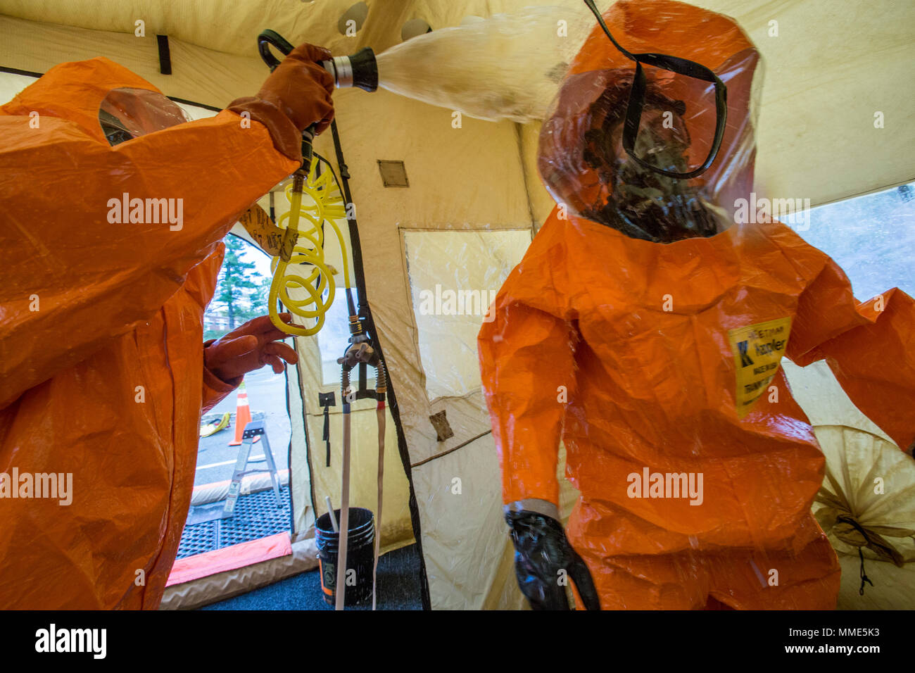 U.S. Army Staff Sgt. Williams, left, decontaminates Sgt. Cory J