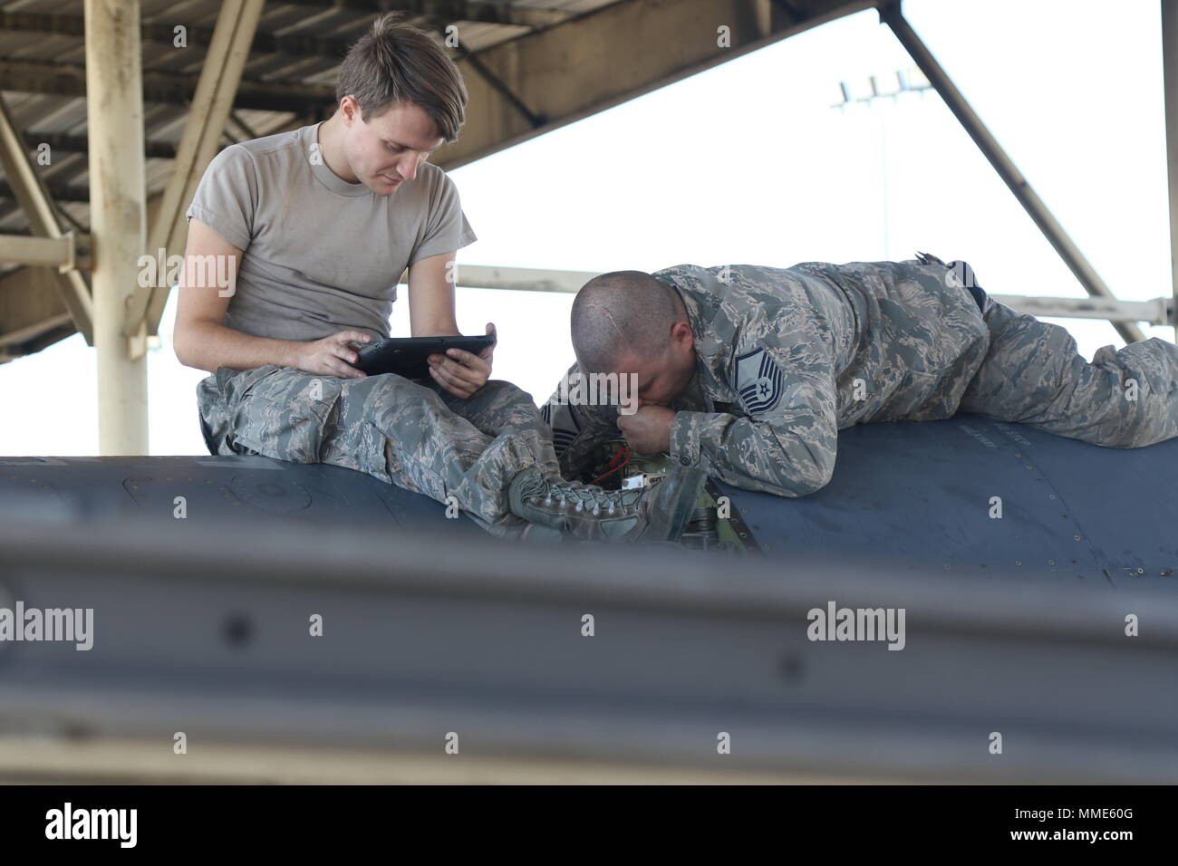 U.S. Air Force Staff Sgt. Jeffrey Deetman and Master Sgt. James Cochran, two electricians of the 187th Fighter Wing, Alabama Air National Guard, repair an F-16 Fighting Falcon, Oct. 26, 2017, at the Montgomery Air National Guard Base, Ala. The wing is participating in Southern Strike 2018, a joint large-scale multinational exercise that provides a cross-domain training environment that will prepare the force for the uncertainty of combat operations. (U.S. Army National Guard photo by Cpl. Justin Humphreys) Stock Photo