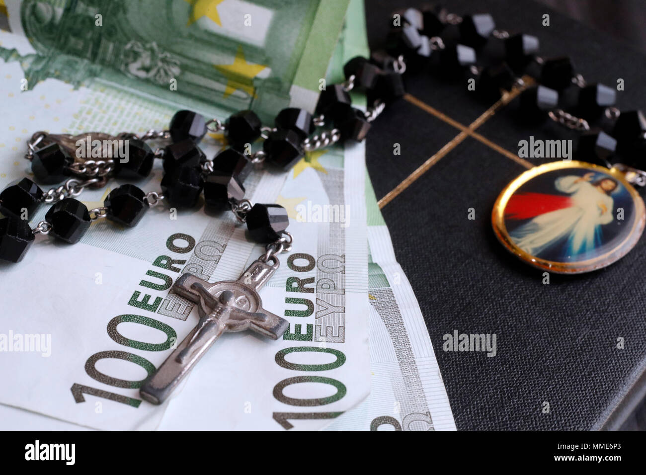 Money and religion. Holy bible and euros. Money and religion. Holy bible and euros. Stock Photo