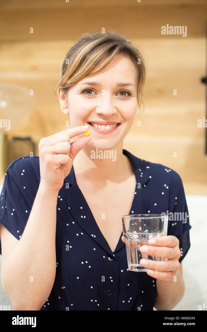 WOMAN TAKING MEDICATION Stock Photo