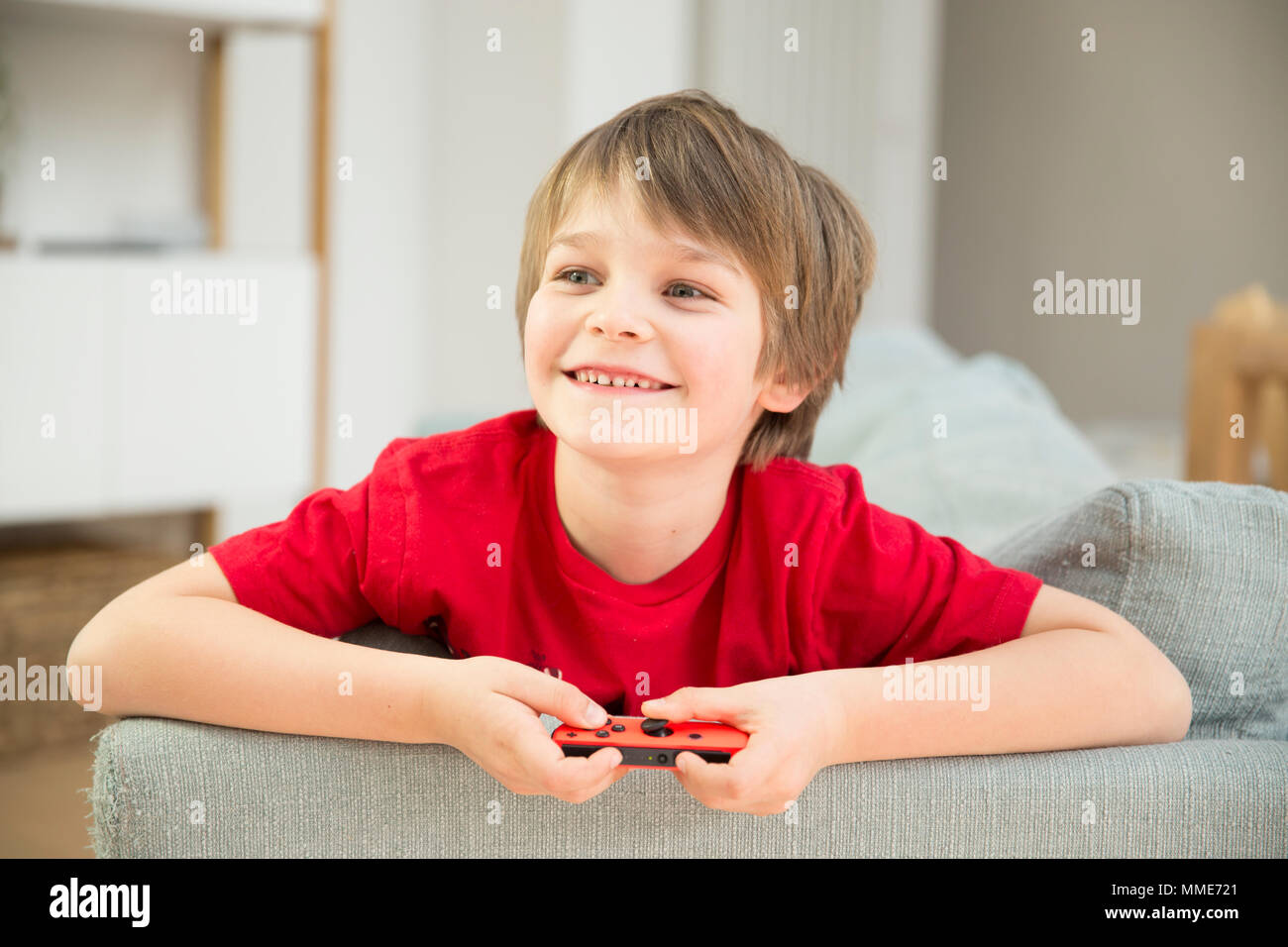 CHILD PLAYING VIDEO GAME Stock Photo