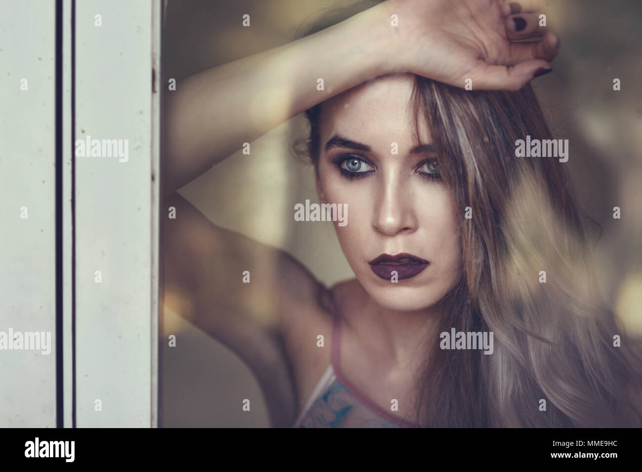 Thoughtful woman looking through the window. Beauty concept Stock Photo