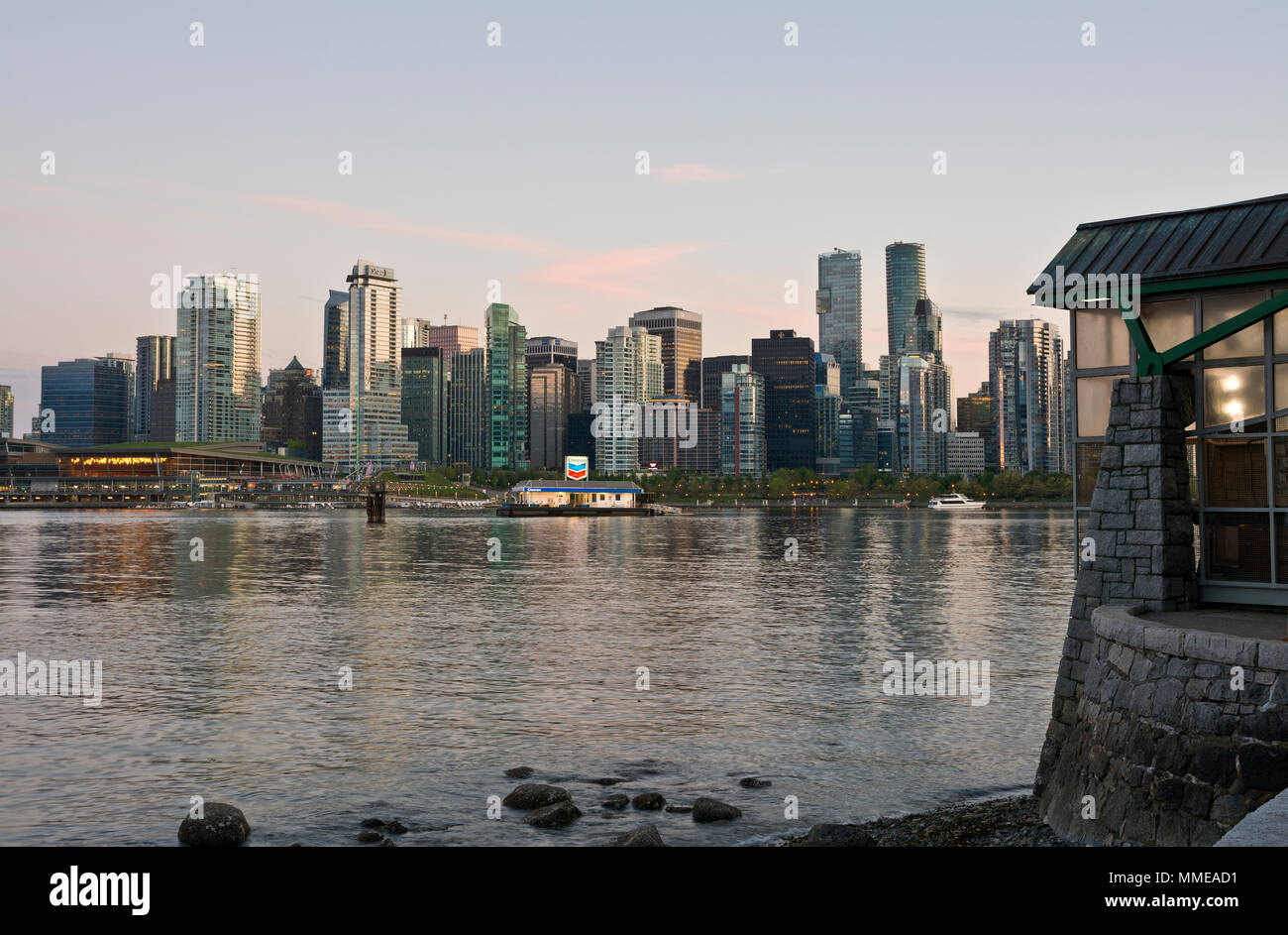 Vancouver city skyline and Coal Harbour at dusk, as viewed from Stanley Park and the 9 o'clock gun. Stock Photo