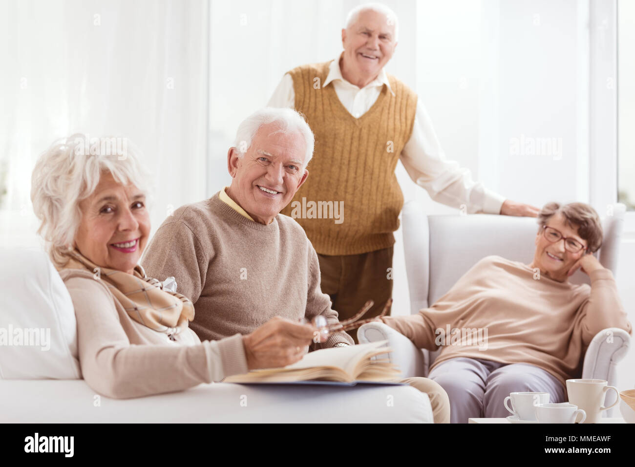 Happy pensioners of retirement home relaxing together Stock Photo
