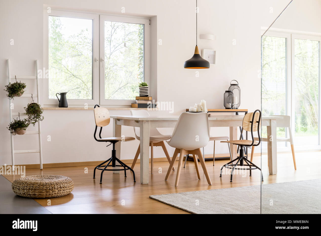 White modern dining hall with big table and designer chairs Stock Photo ...