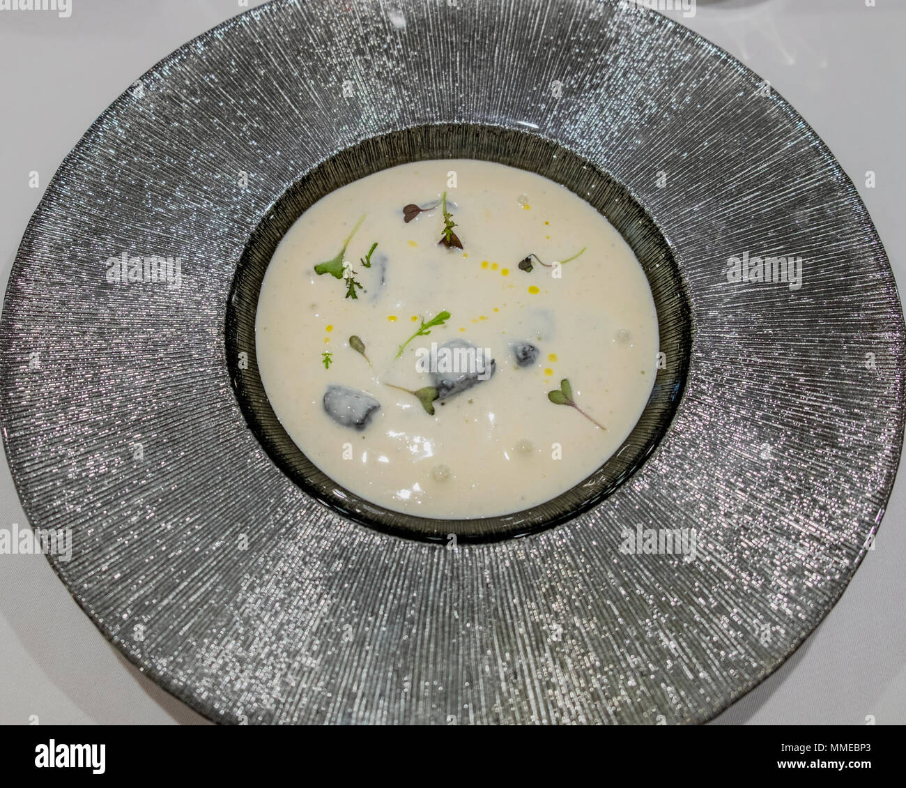 Gnocchi with squid ink and gorgonzola foam sauce, starter plate Stock Photo