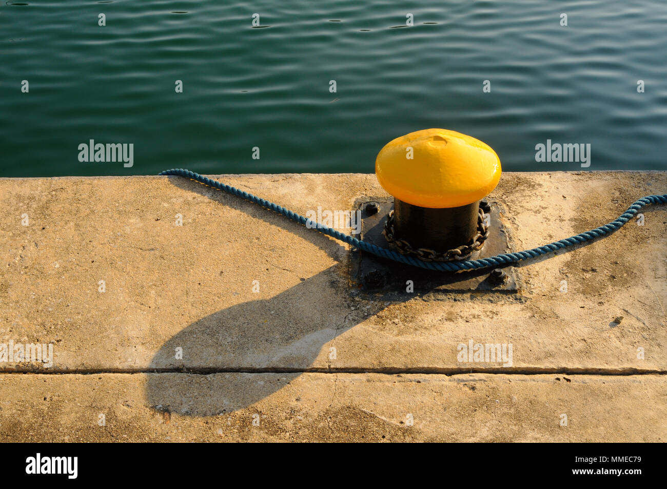 Blue rope and mooring hook by the pier Stock Photo