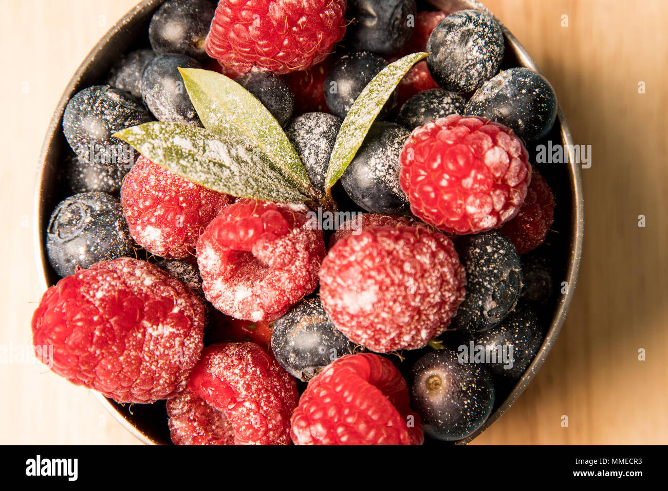 Close up of mixed berries in a copper bowl Stock Photo