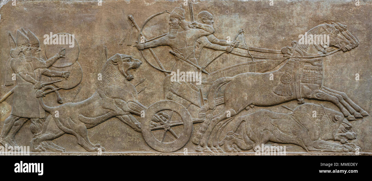 London. England. British Museum. King Ashurnasirpal II Hunting Lions. Stone wall panel relief, (865-860 BC) from the North-West Palace of Ashurnasirpa Stock Photo