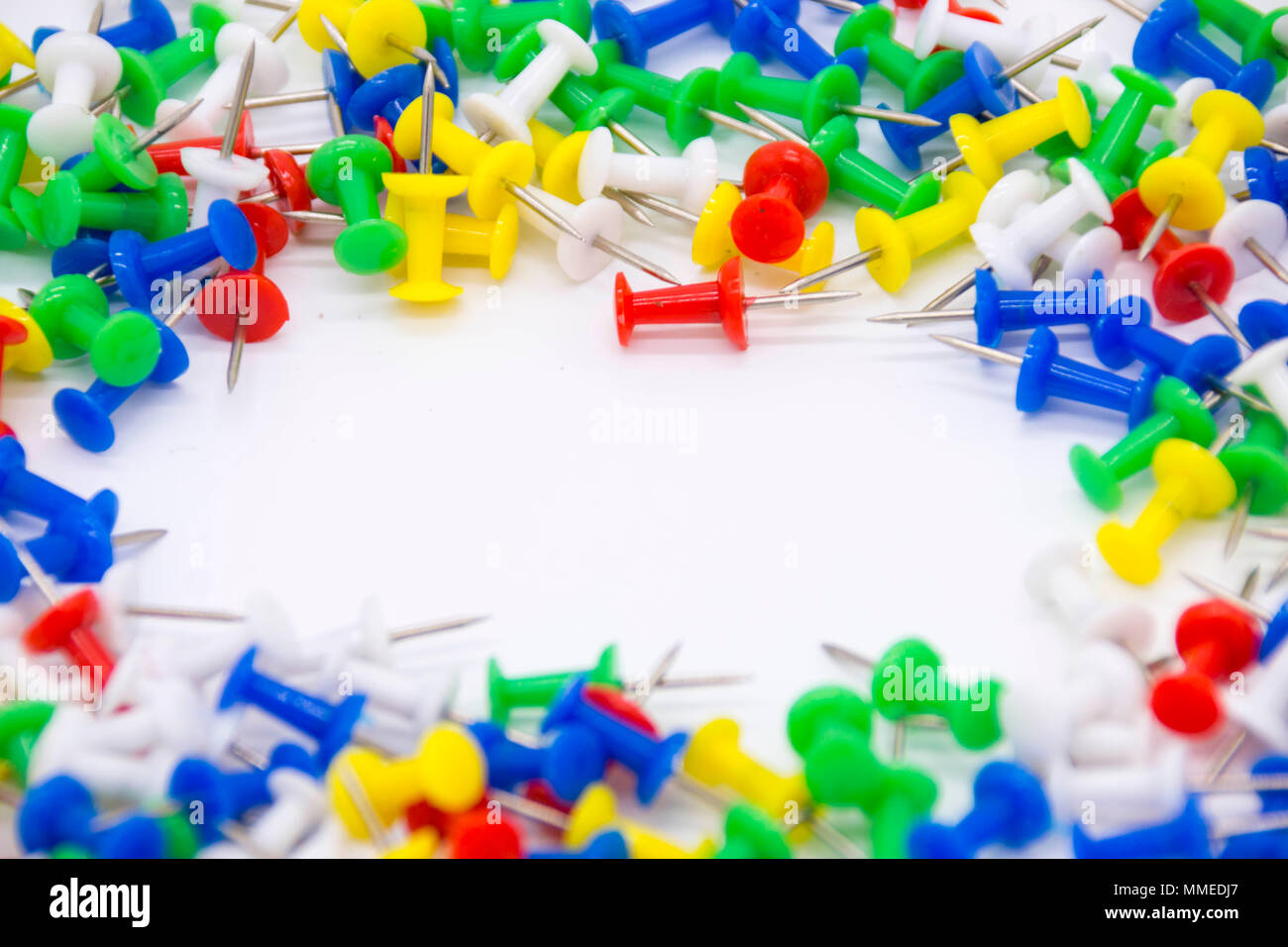 Pile of plastic notice board push pins on a white background Stock