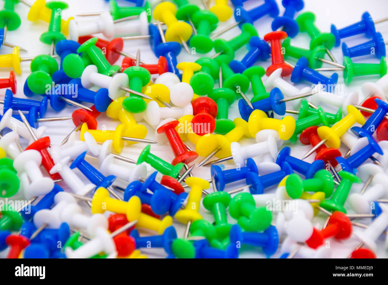 Pile of plastic notice board push pins on a white background Stock