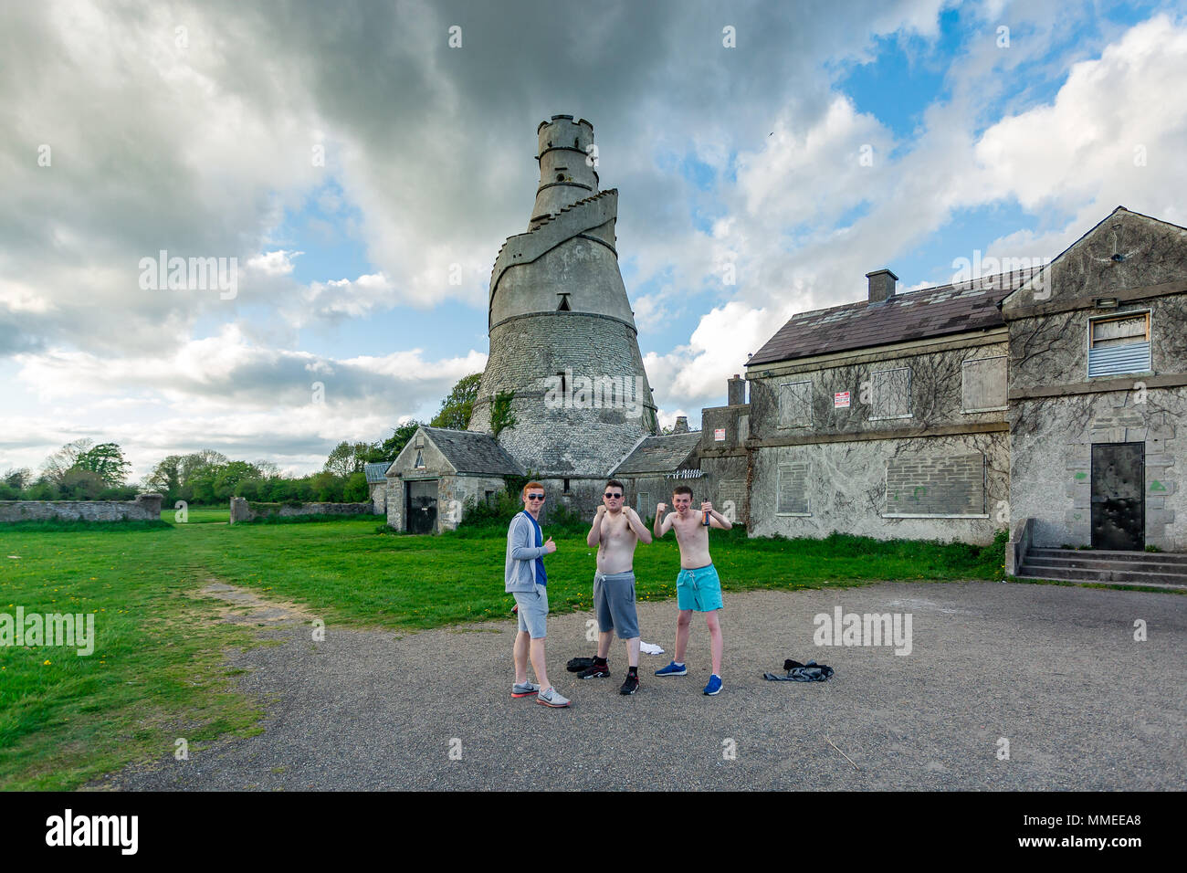 Young men messing posing to photo with bottles of beer at the Wonderful Barn build on the edge of Castletown House Estate, Leixlip, Kildare, Ireland Stock Photo