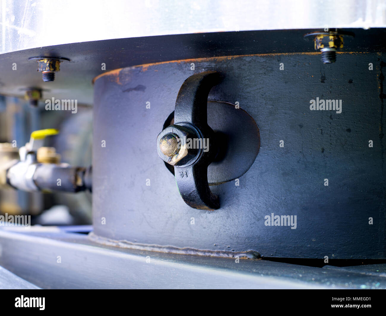 Removing and replacing the hand hole and gasket on a boiler Stock Photo