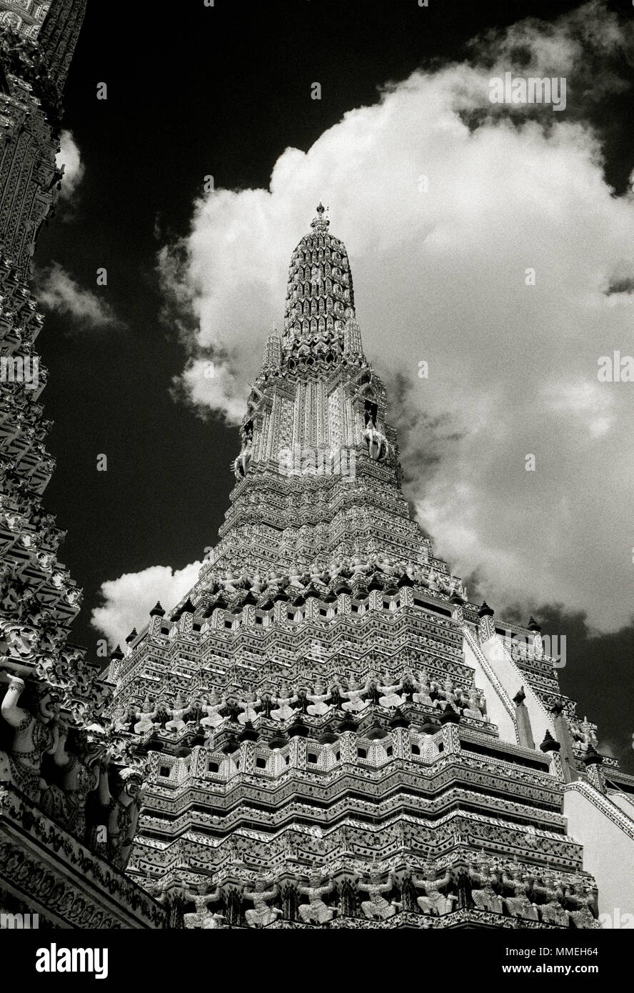 Dramatic chiaroscuro sky and the Buddhist Temple of Dawn - Wat Arun Temple in Thonburi Bangkok Yai in Thailand in Southeast Asia Far East. Travel B&W Stock Photo
