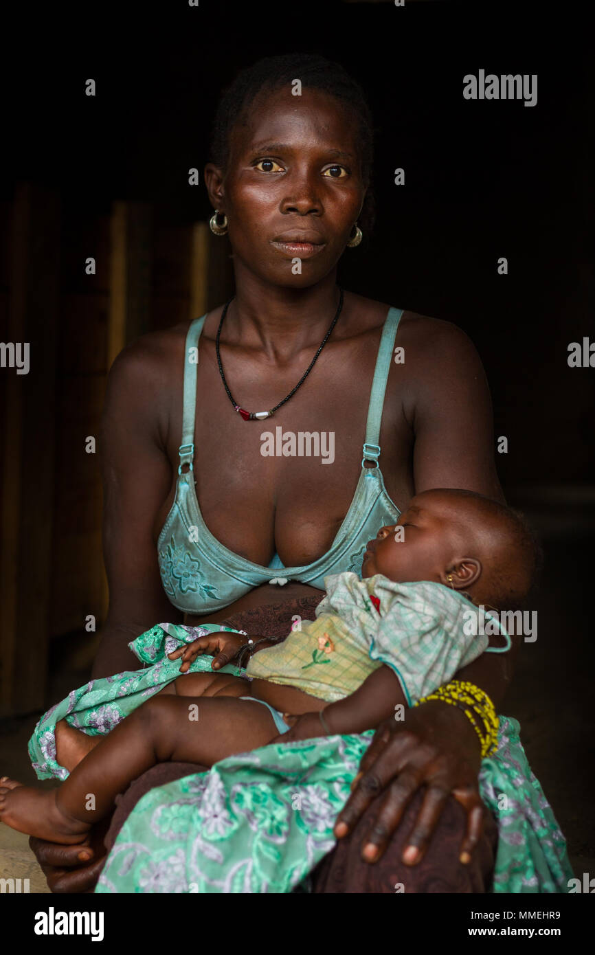 YONGORO, SIERRA LEONE - June 06, 2013: West Africa, unknown woman with baby son with an age of a few months while sleeping near the capital Freetown,  Stock Photo