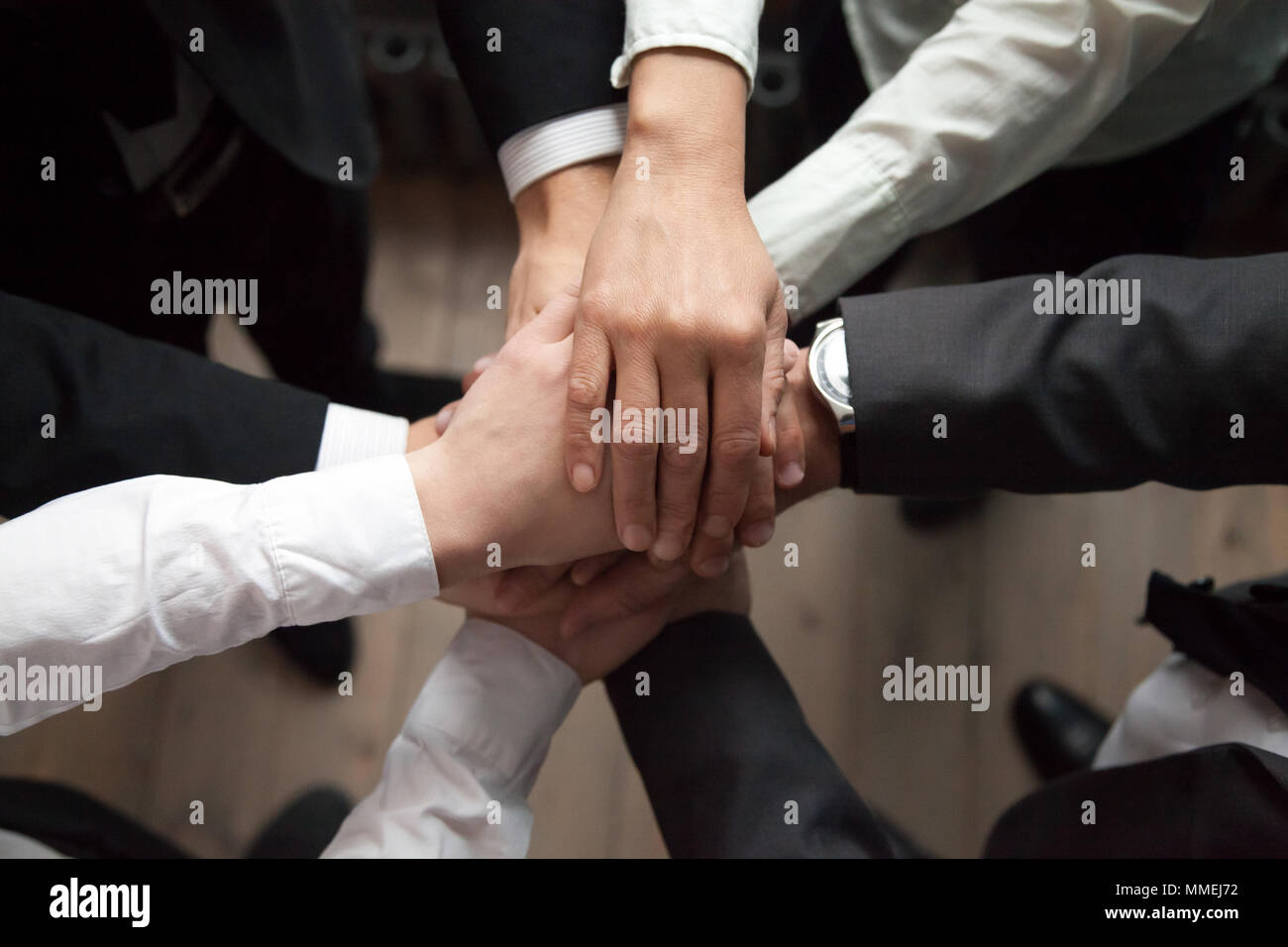 Motivated business people put hands together, trust and support  Stock Photo