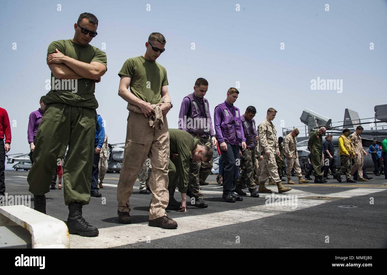 180510-N-ZK016-0026 U.S. 5TH FLEET AREA OF OPERATIONS (May 10, 2018) Sailors and Marines conduct a foreign object damage walk-down on the flight deck of the Wasp-class amphibious assault ship USS Iwo Jima (LHD 7), May 10, 2018, May 10, 2018. Iwo Jima, homeported in Mayport, Fla. is on deployment to the U.S. 5th Fleet area of operations in support of maritime security operations to reassure allies and partners, and preserve the freedom of navigation and the free flow of commerce in the region. (U.S. Navy photo by Mass Communication Specialist 3rd Class Joe J. Cardona Gonzalez /Released). () Stock Photo
