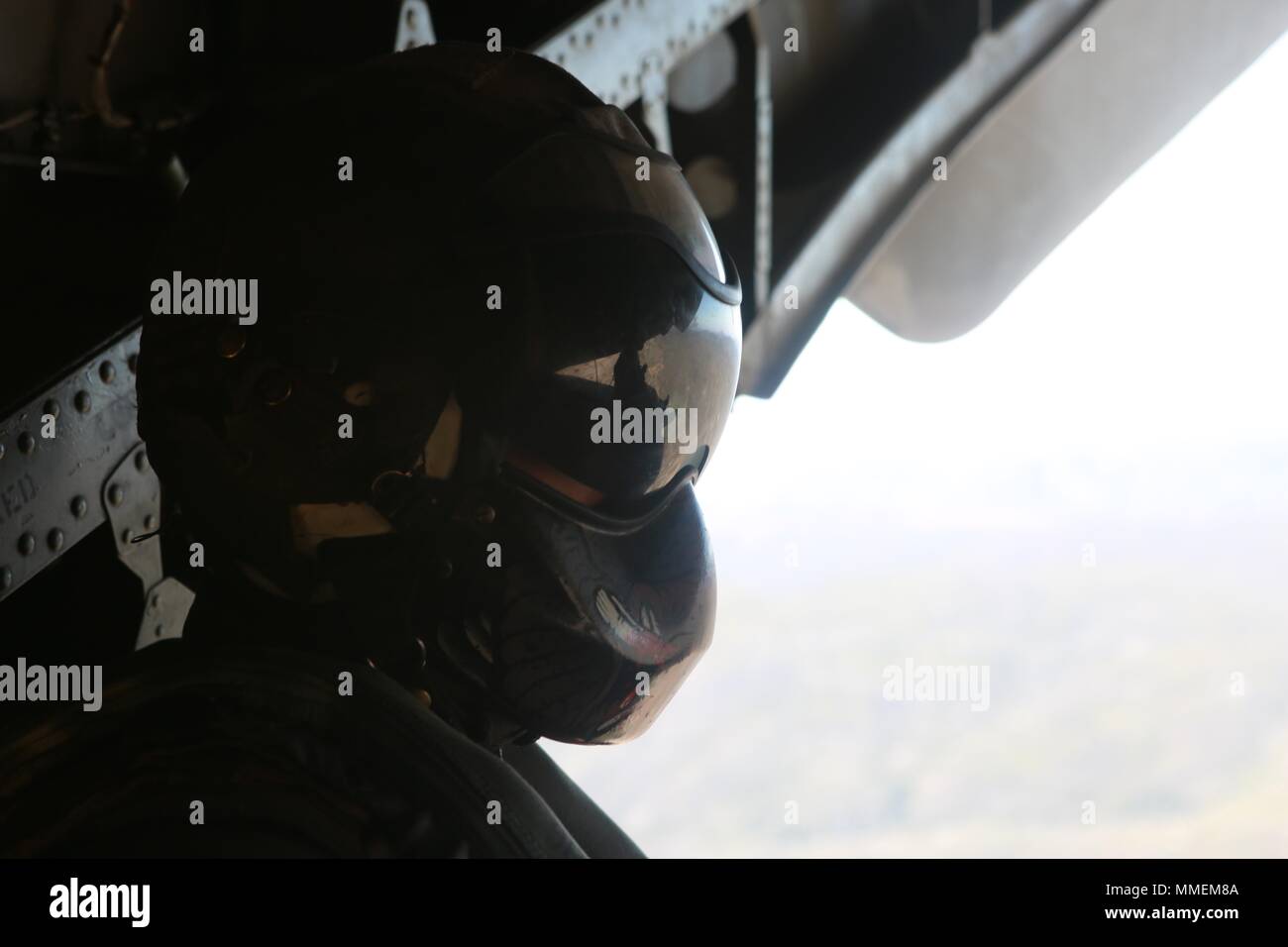 Marines with Marine Heavy Helicopter Squadron (HMH) 465 conduct quick launch and landing drills in a CH-53E Super Stallion at Marine Corps Air Station Miramar, Calif., Oct. 18. Sgt. Adam B. Collins, a crew chief with HMH-465, observes the back of the aircraft in order to aid the pilots in maintaining a safe distance from the ground, other aircraft and nearby objects. (U.S. Marine Corps photo by Lance Cpl. Victor Mincy/Released) Stock Photo