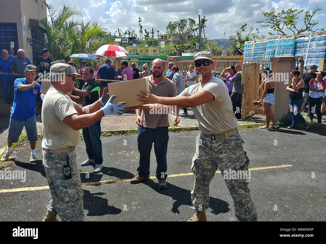 United States Army Reserve and Puerto Rico National Guard Soldiers assist  with food and water delivery to the San Antonio sector of Caguas, Puerto  Rico, October 24. The supplies were delivered to